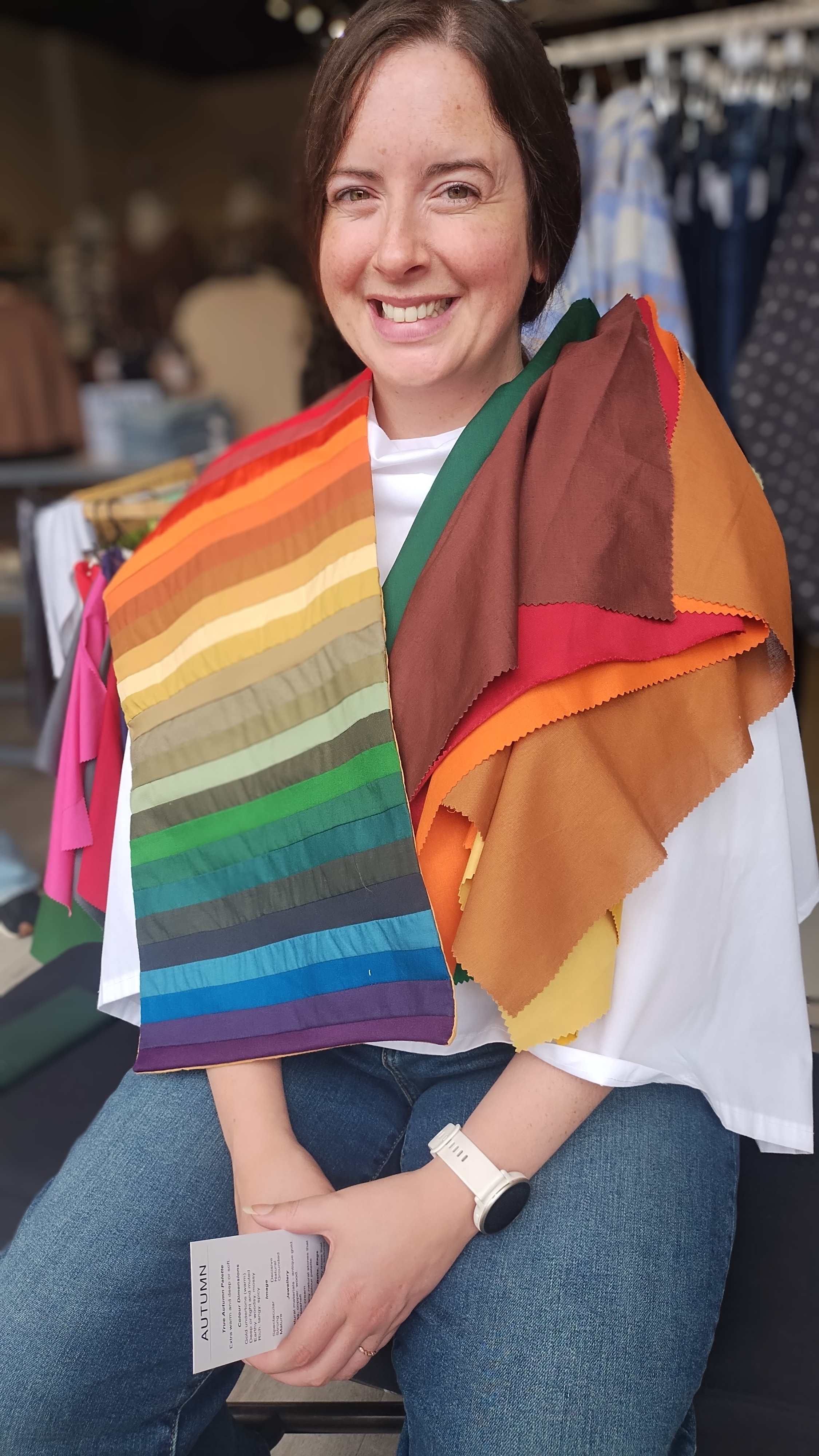 Client draped in warm autumn colour swatches during a Glow Blossom Colours session