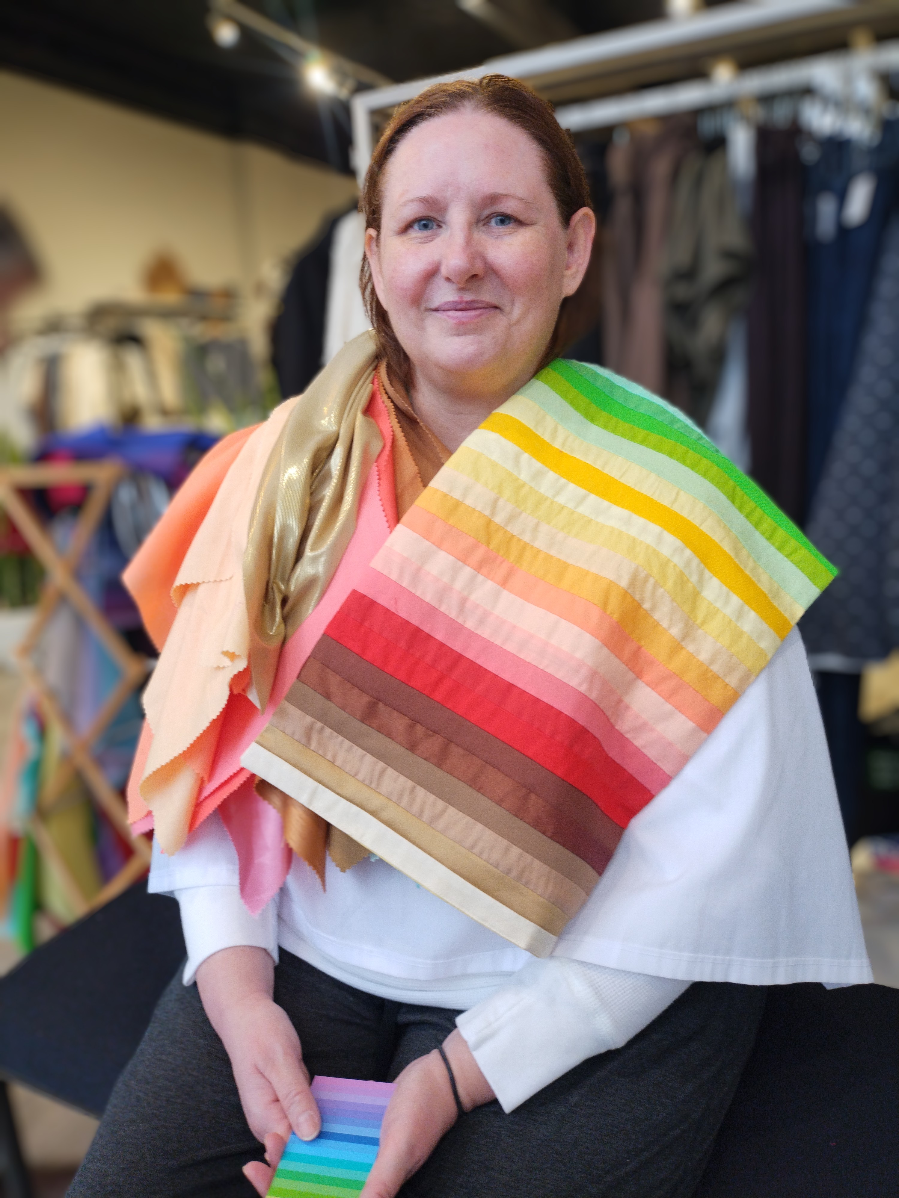 Client draped in light warm colour swatches during a Glow Blossom Colours session