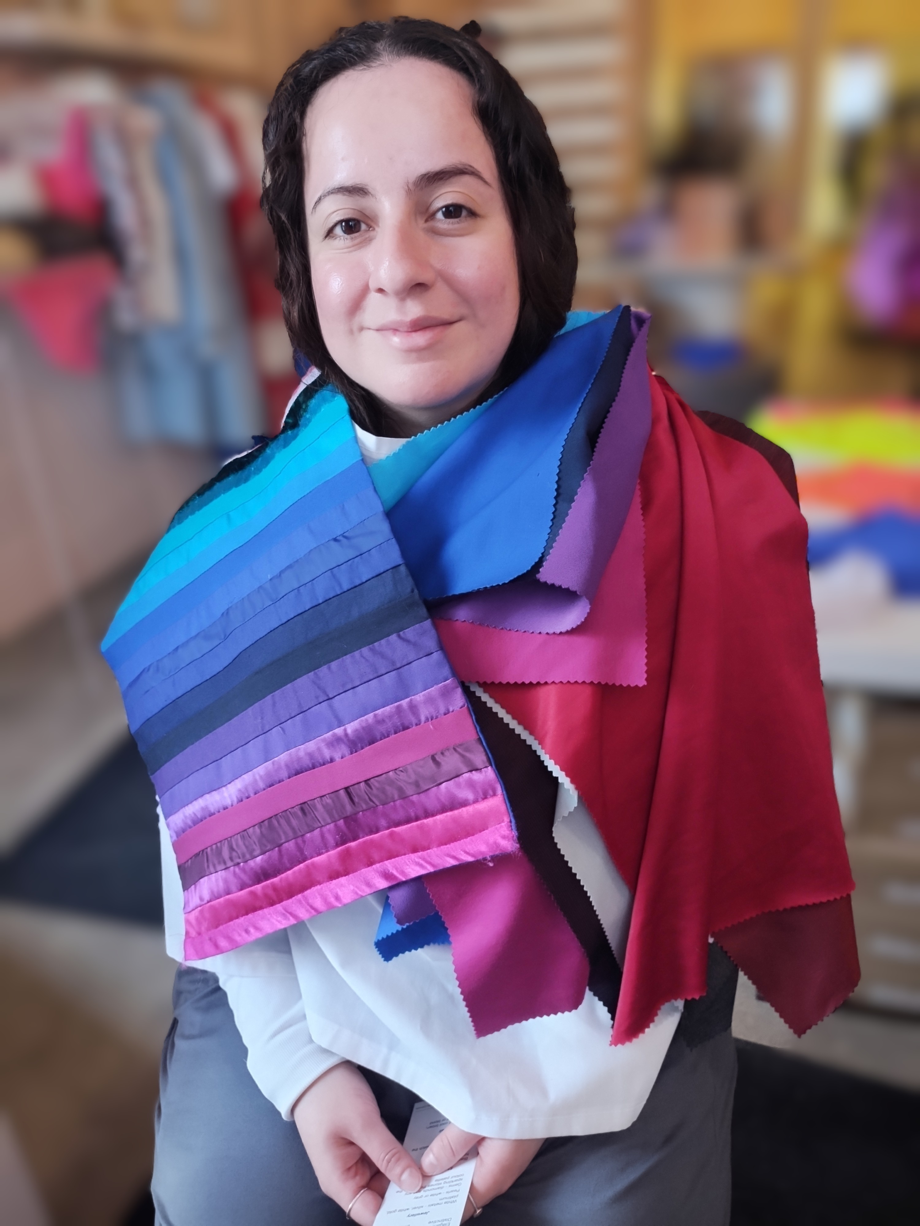 Client draped in cool jewel-tone colour swatches during a Glow Blossom Colours session