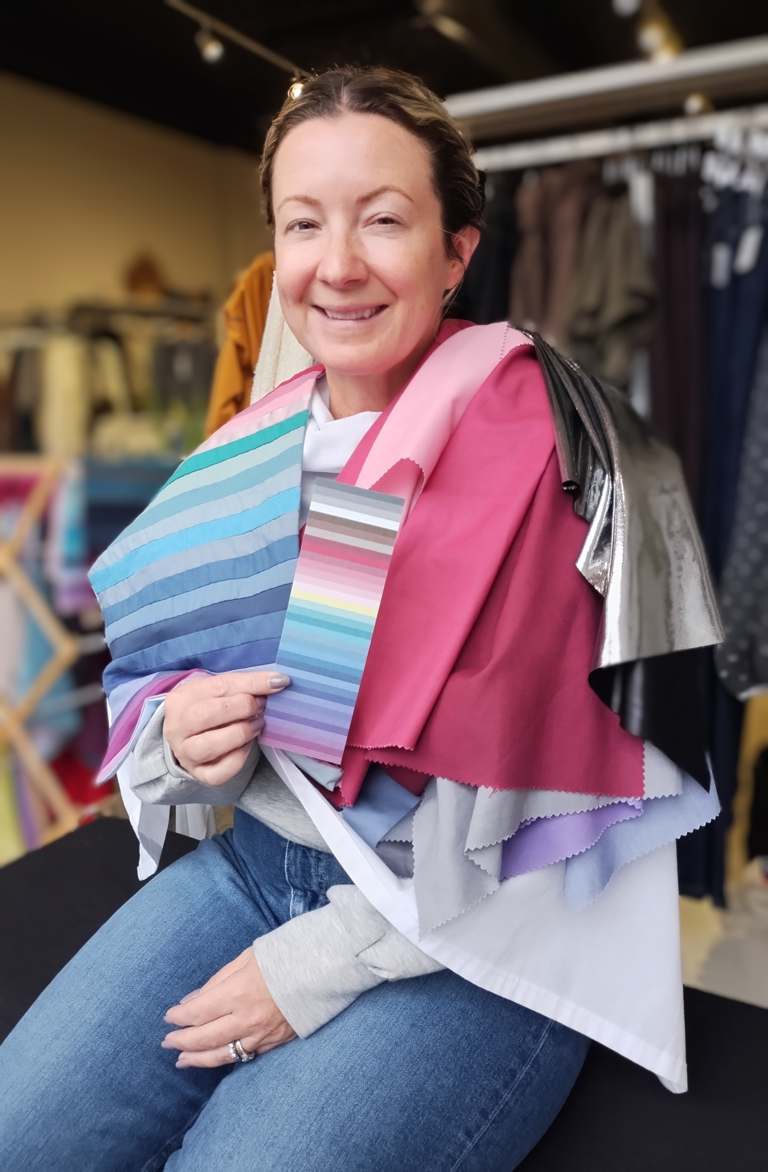 Client draped in cool pink and blue colour swatches during a Glow Blossom Colours session